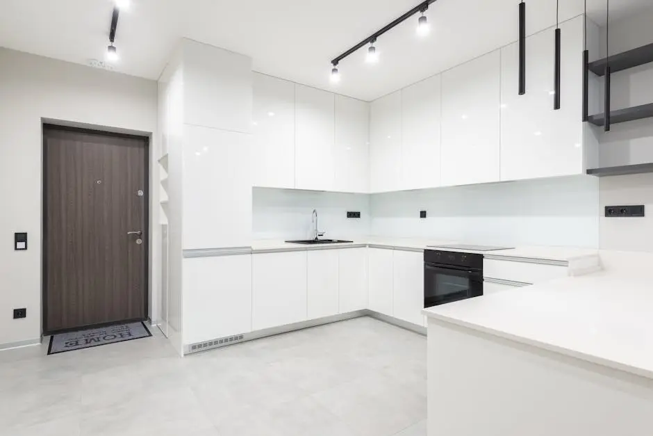 Sleek and spacious white kitchen interior with modern minimalist design and ample space.