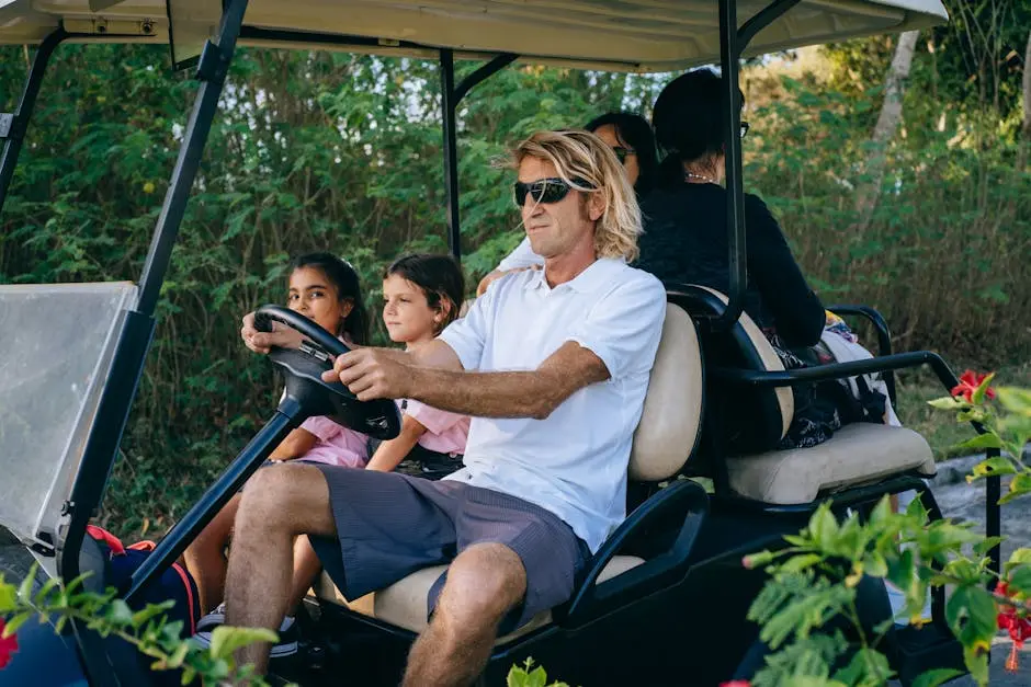 A family with children enjoys a relaxing ride in a golf cart surrounded by nature.