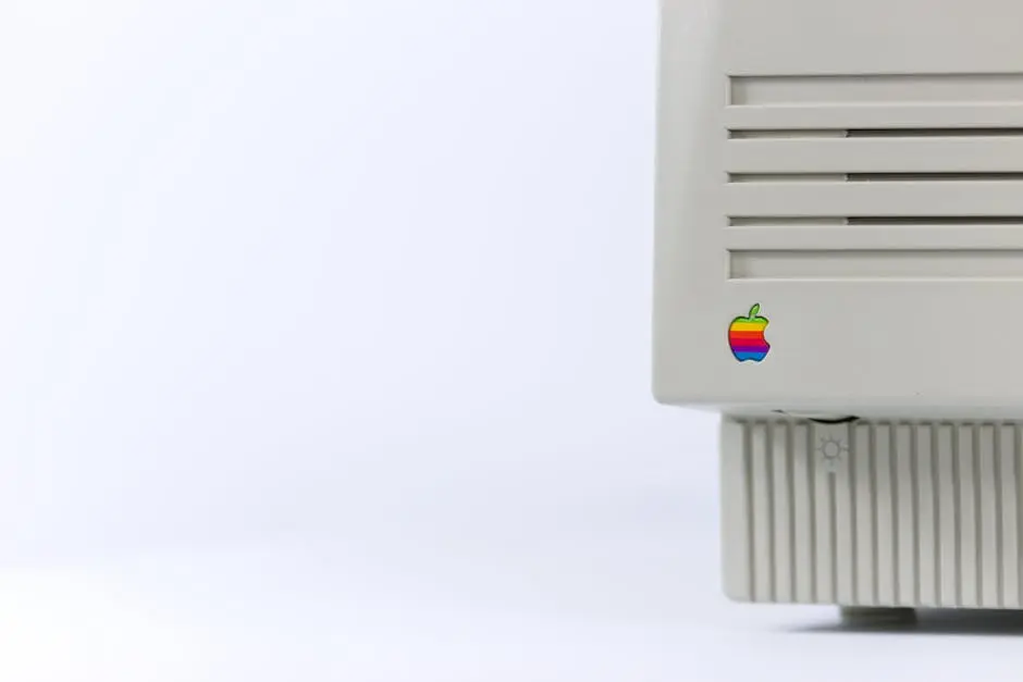 Close-up of a vintage computer monitor featuring a colorful logo on a minimalist background.