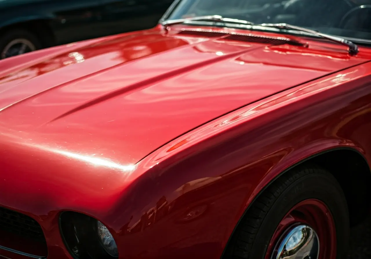 A close-up of a polished car hood reflecting sunlight. 35mm stock photo