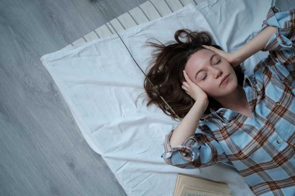 Young woman relaxing indoors on a bed, thinking about Career Change