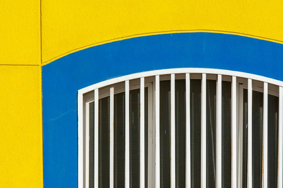 A vibrant facade with yellow and blue colors surrounding an arched window.