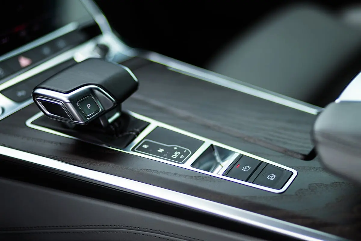 Close-up view of a sleek automatic gearbox in a luxurious car interior.