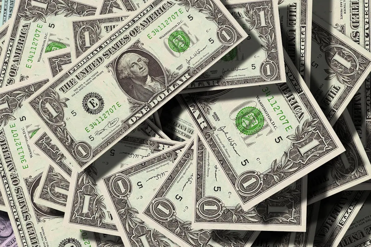 Close-up of scattered US dollar bills symbolizing finance and wealth.