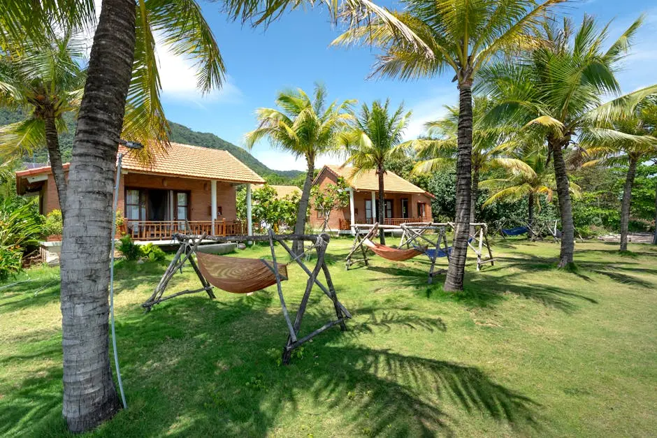 Tranquil tropical resort featuring palm trees, hammocks, and cozy bungalows under a bright summer sky.