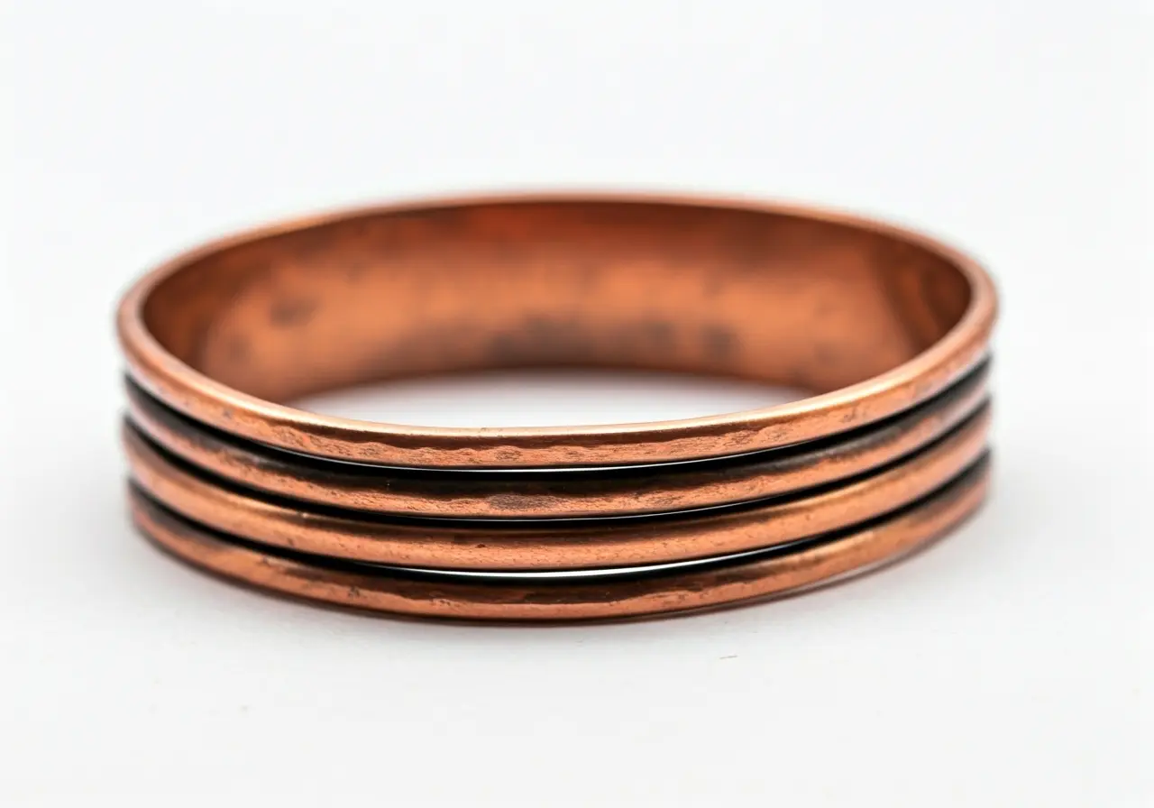 A close-up of a copper bracelet on a white background. 35mm stock photo