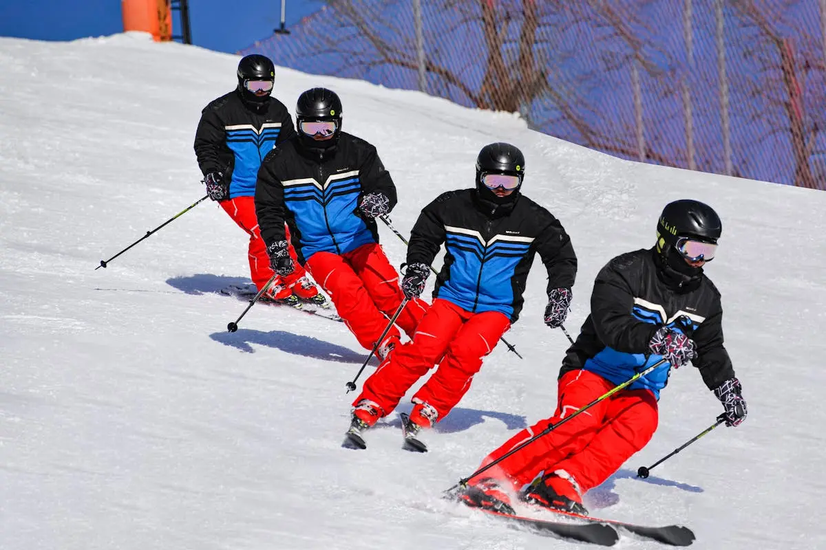 A synchronized team of skiers in action on a snowy winter slope, showcasing coordination and skill.