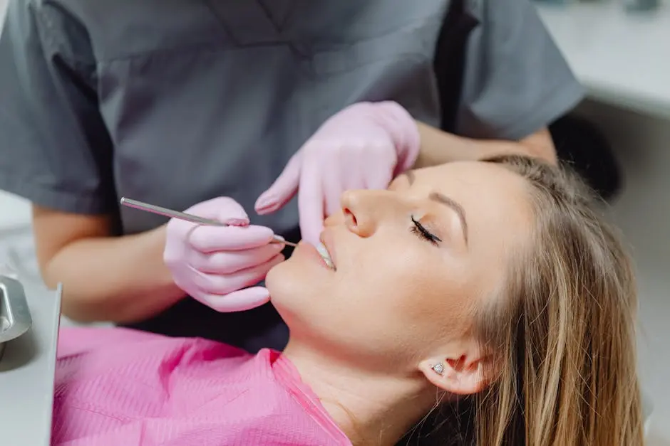 A female patient receives a dental examination by a dentist in a clinic.