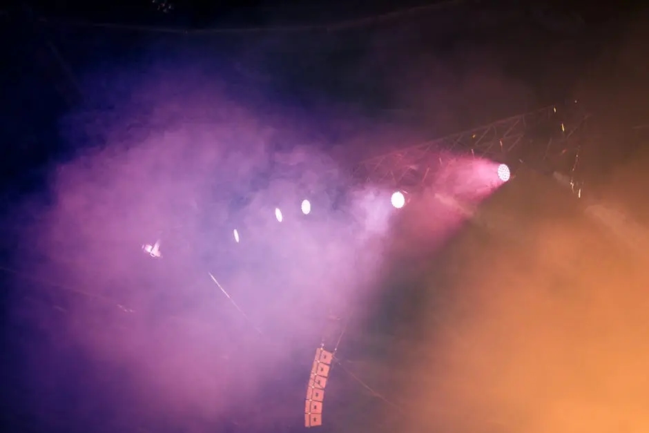 Dynamic stage scene with colorful lighting and fog, creating a vibrant atmosphere.