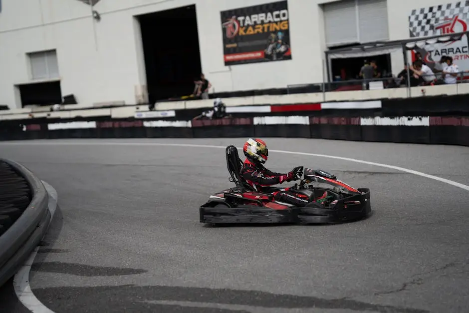 A go-kart racer wearing a helmet speeds on the track at Tarraco Karting. Captures the thrill of motorsport racing.