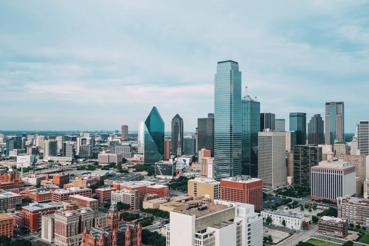 Aerial view of the vibrant Dallas skyline with iconic skyscrapers and urban landscape.