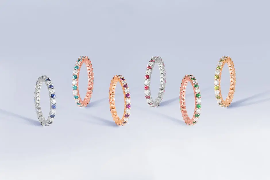 A stunning collection of elegant, vibrant gemstone rings in a studio setting.