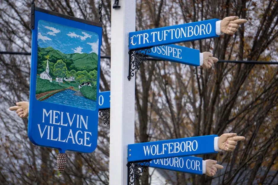 Colorful directional signs with hands pointing in Melvin Village, New Hampshire