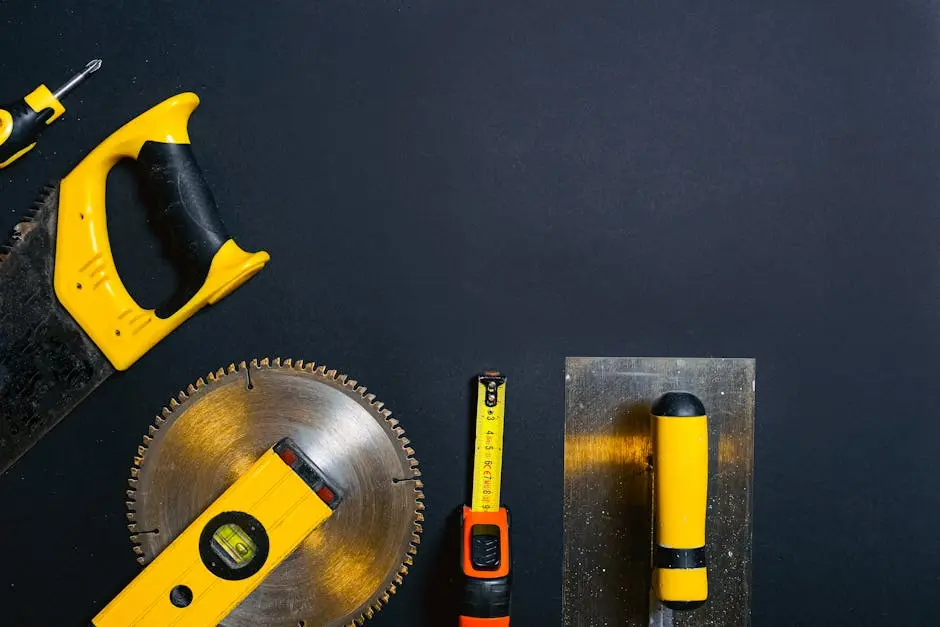 Hand tools arranged on a black surface, featuring saws, levels, and a tape measure.