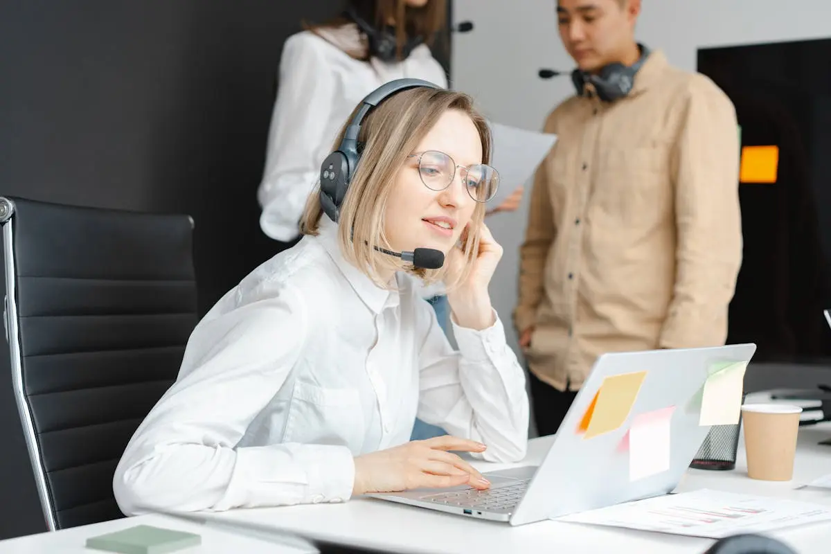 fractional coo professionals working with headsets and laptops in a modern office environment.