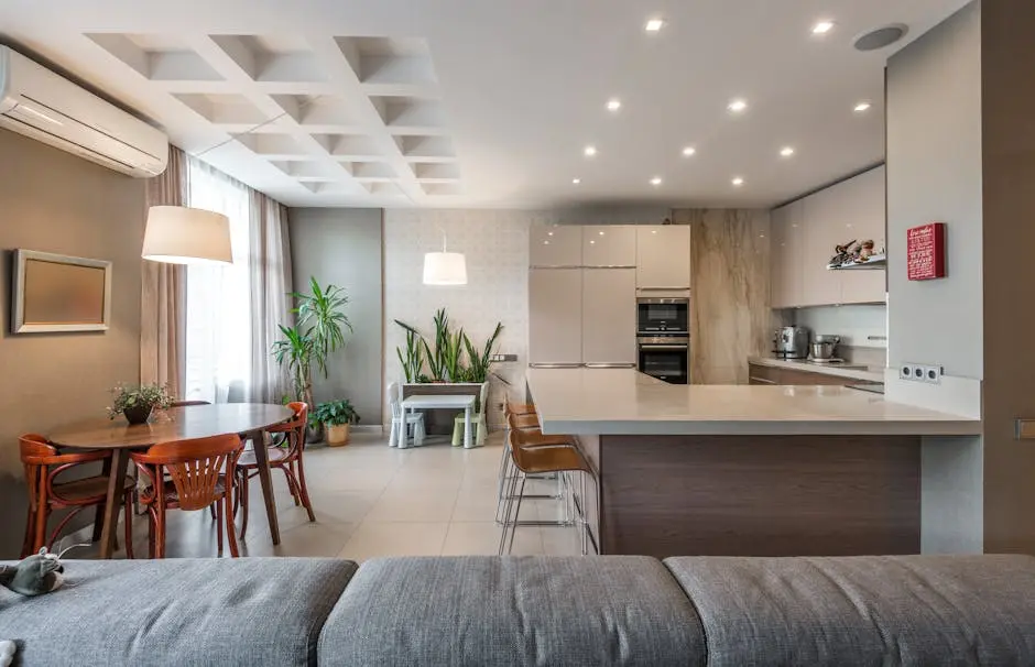 Spacious modern kitchen and dining room with stylish furniture and lighting.