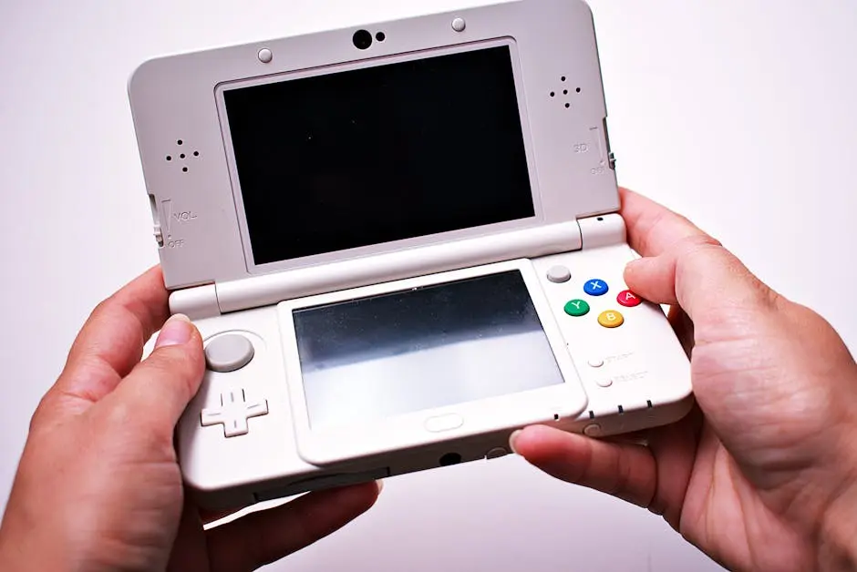 Close-up of hands holding a white portable gaming console with dual screens.