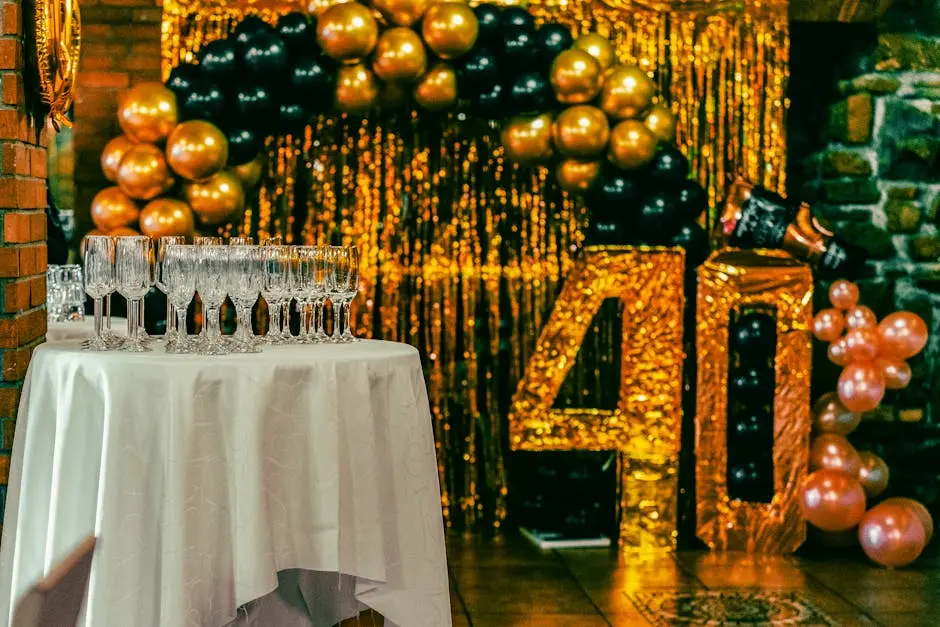 Chic 40th birthday party setting with champagne flutes, balloons, and gold glitter backdrop.