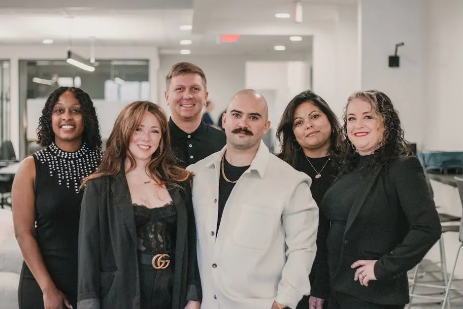 Diverse real estate professionals posing confidently in a modern office environment.