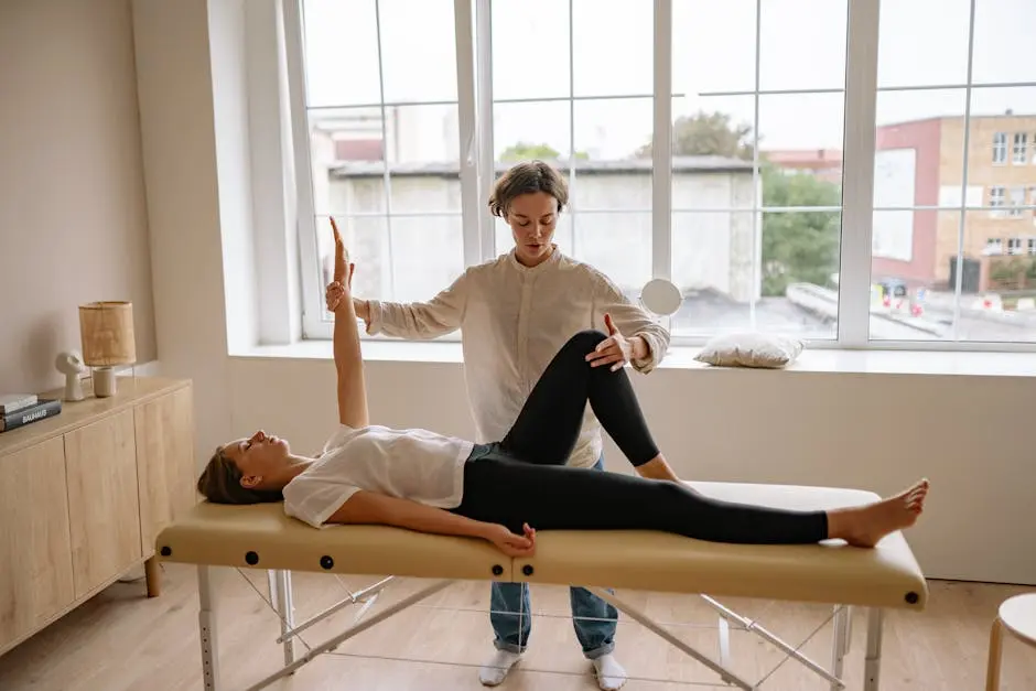 A specialist performs therapy on a woman lying on a massage table in a modern clinic setting.