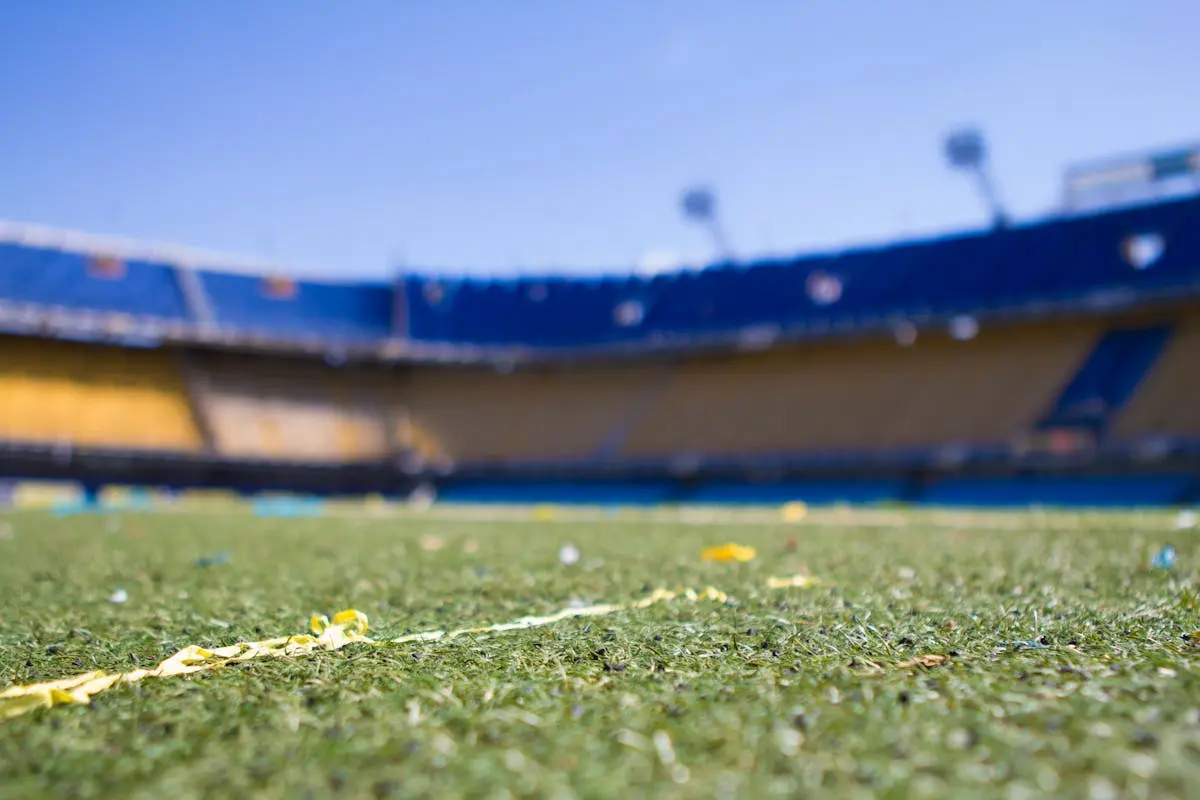 Close-up view of a vibrant football pitch in a sunlit Buenos Aires stadium, perfect for sports enthusiasts.