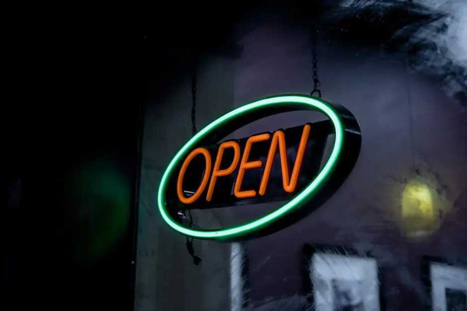 Vibrant neon open sign glowing in a dimly lit setting, creating a welcoming ambiance.