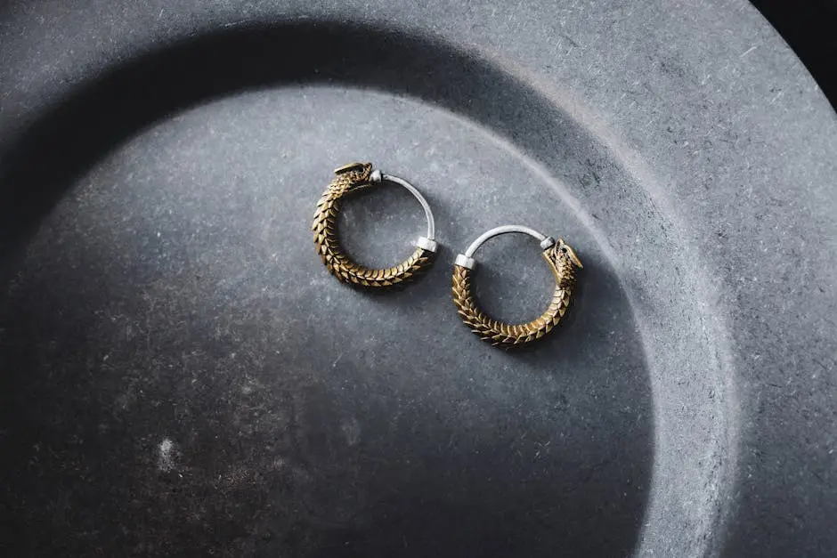 Sophisticated chunky gold hoop earrings elegantly displayed on a dark stone surface, showcasing luxury and style.