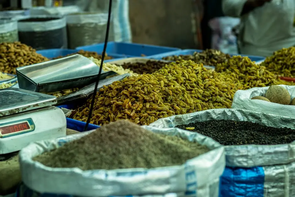 A vibrant spice market stall in Delhi displaying various spices and grains in sacks.