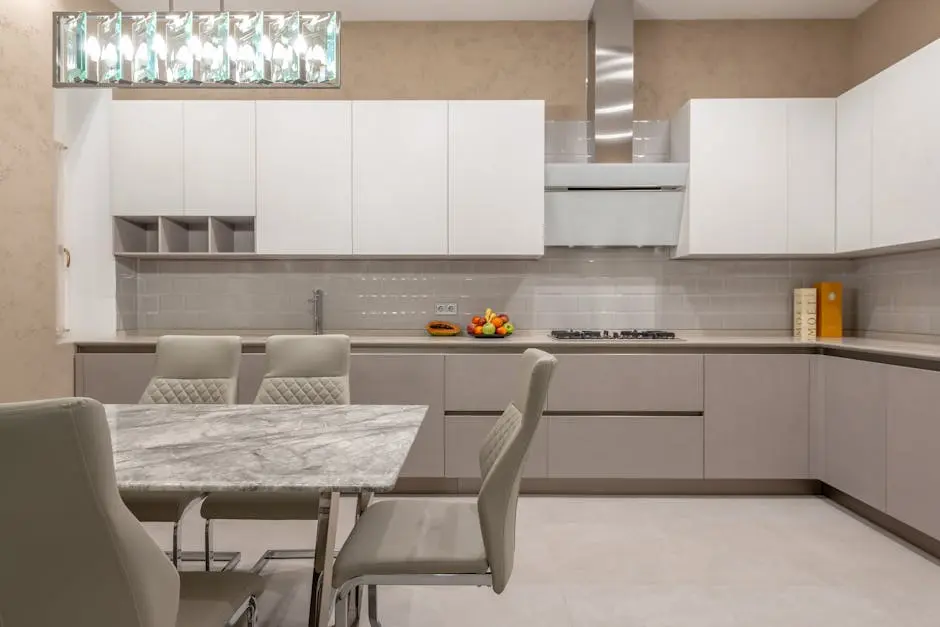 Elegant contemporary kitchen design featuring a marble table and sleek cabinetry.