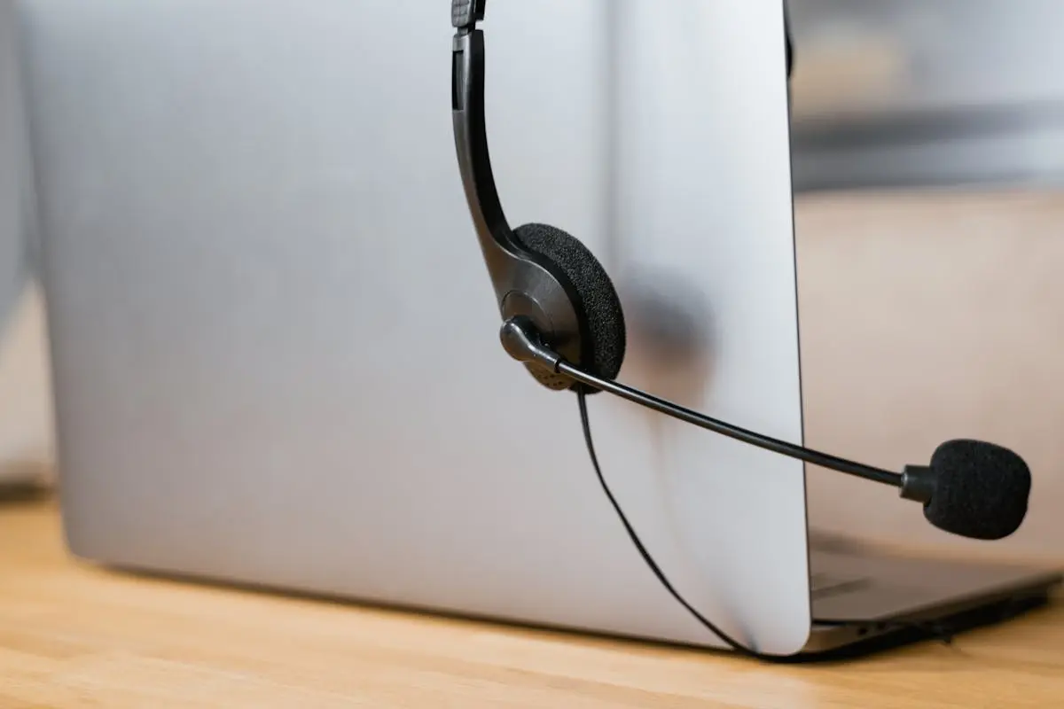 A laptop with a headset attached, ideal for virtual meetings or online customer support. Virtual CFO