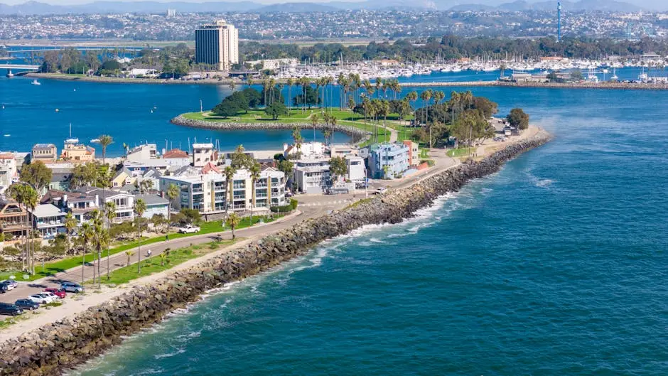 Stunning drone shot of San Diego’s coastline, showcasing urban cityscape and ocean views.