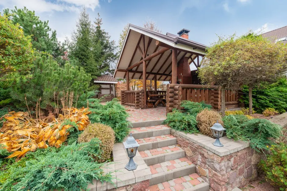 Beautiful rustic pergola surrounded by diverse greenery and stone steps, creating a serene outdoor retreat.