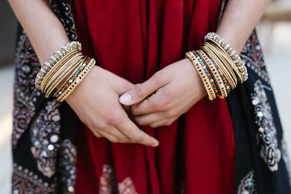 Close-up of a woman’s hands adorned with colorful traditional bangles, showcasing cultural attire.