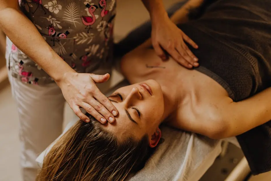 A tranquil scene of a woman receiving a therapeutic head massage at a spa.