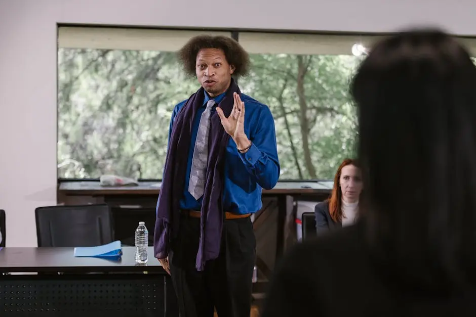 Business professional presenting to an attentive audience in a modern seminar setting.