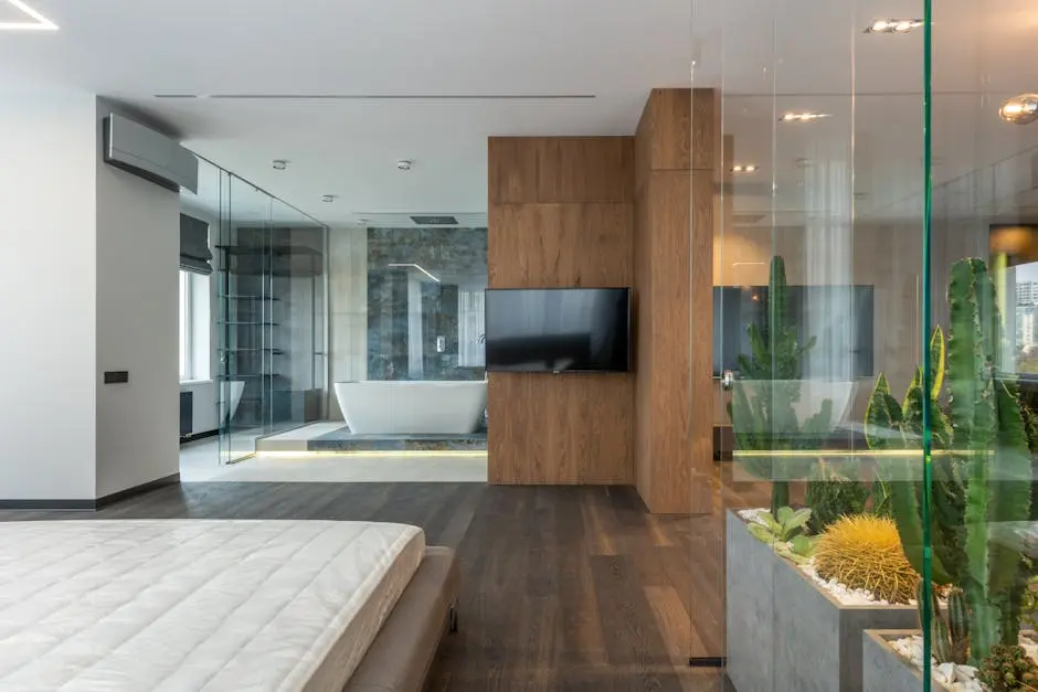 Interior of modern apartment with bedroom and bathroom with transparent glass walls
