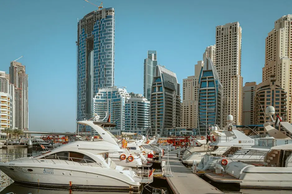 Stunning view of luxury yachts docked in Dubai Marina with the modern skyscrapers in the background.
