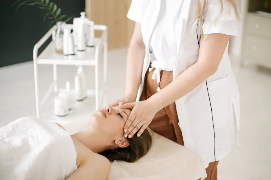 A woman receives a soothing head massage in a tranquil spa setting.