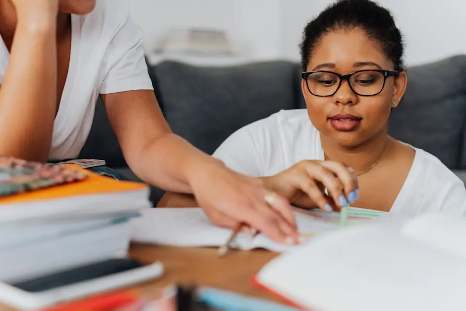 Focused learning session with a tutor and an African American woman, studying together at home.