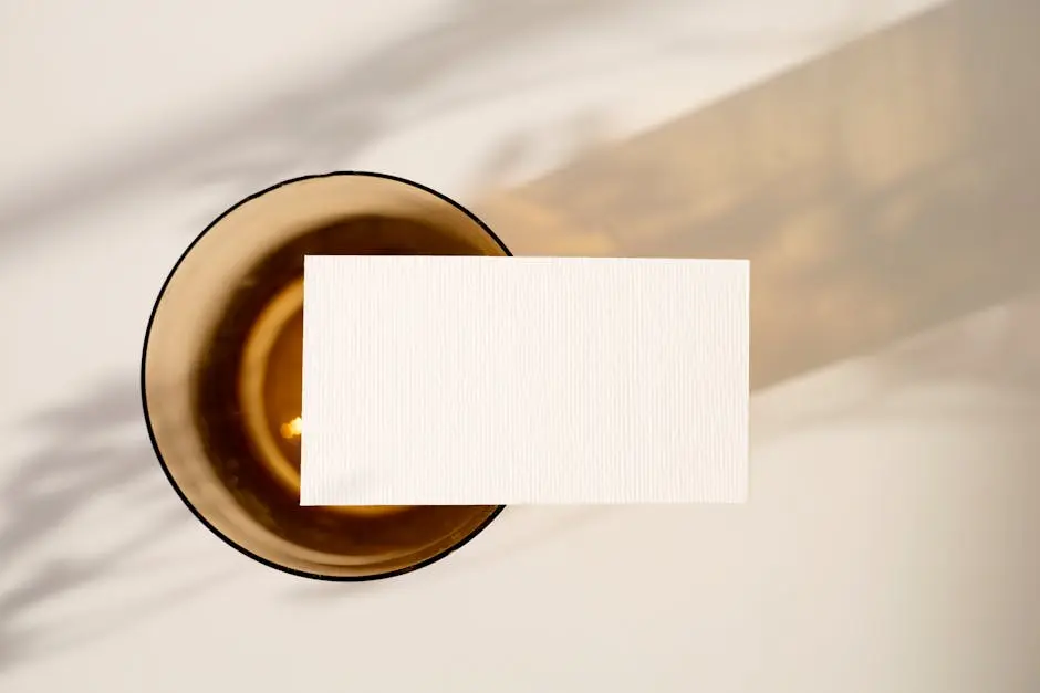 Top view of a blank card on a minimalist surface, ideal for mockup designs.