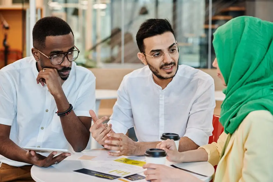 Candid image of a diverse team in a collaborative meeting. Focus on conversation and teamwork.