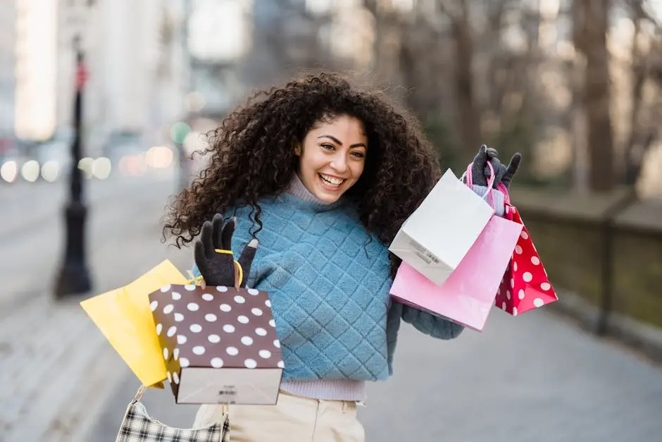 Happy woman holding colorful shopping bags outdoors. Urban setting and cheerful mood.