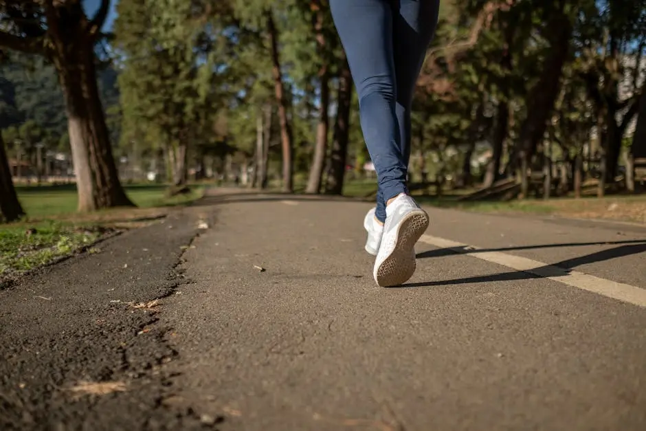 A woman jogging on a path through a park, showcasing fitness and healthy lifestyle outdoors.