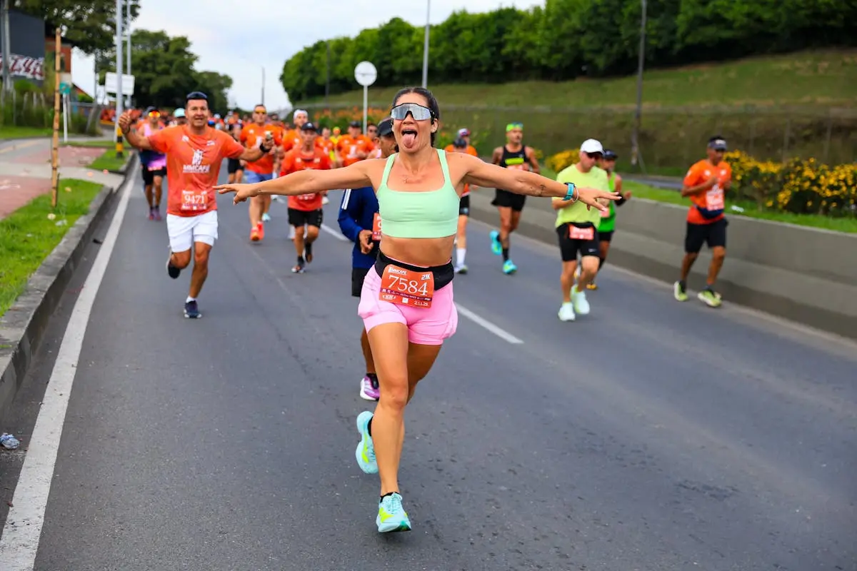 Group of enthusiastic runners enjoying a vibrant outdoor marathon event.