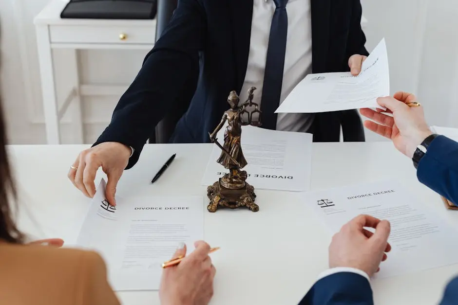 Three adults discussing divorce documents in a formal office setting with legal statue in view.