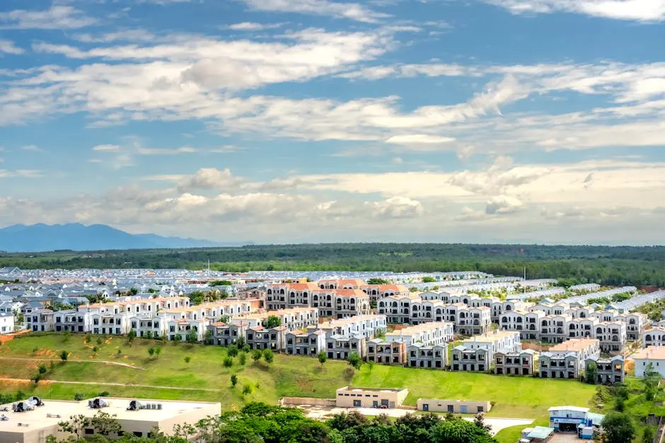 Panoramic aerial snapshot of a suburban residential area with lush greenery under a blue sky.