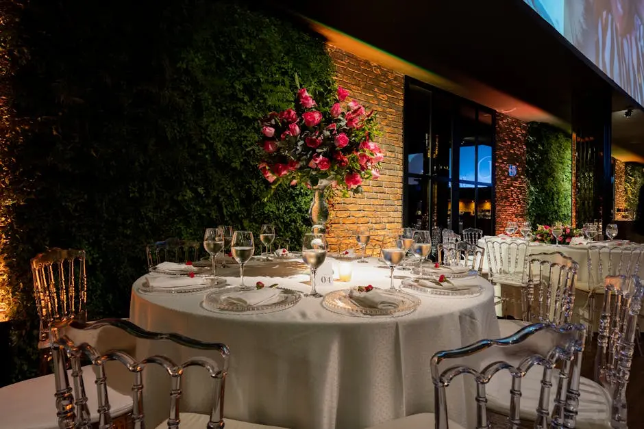 Elegant wedding reception with luxurious table settings featuring floral arrangements and glassware.
