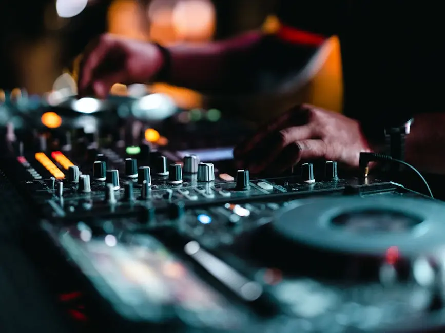 Close-up of a DJ performing with an audio mixer, capturing the energy of a vibrant club scene.