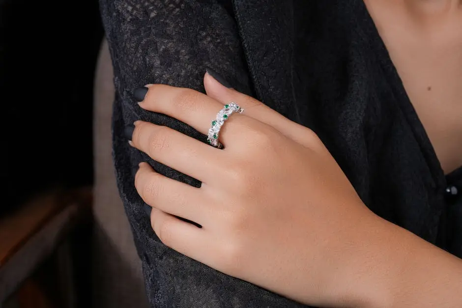Close-up of a hand adorned with a sparkling diamond ring, showcasing fine jewelry.