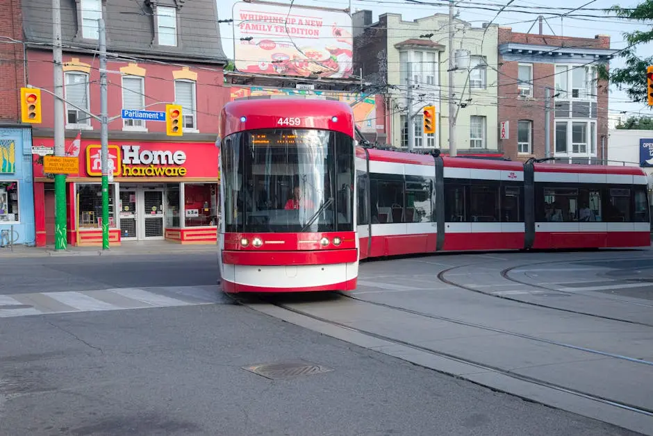 A streetcar traverses downtown Toronto near Parliament Street, showcasing urban transit.